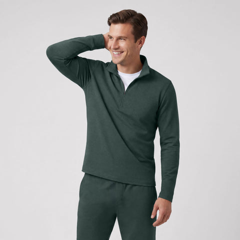 A man wearing the Clubhouse Range Quarter-Zip in Alpine Green