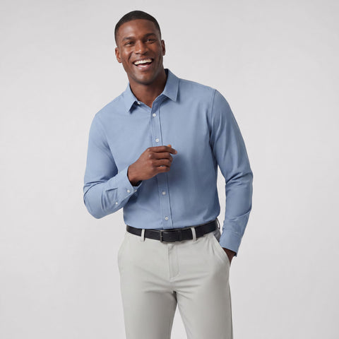 A man wearing the Everywear Shirt Standard Length in Chambray Blue with a classic fit.