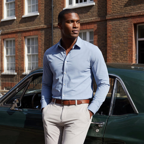The Everywear Shirt Standard Length in Chambray Blue worn in a lifestyle setting.