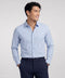 A man wearing the Everywear Shirt Standard Length in Fine Stripe with a button-down collar.