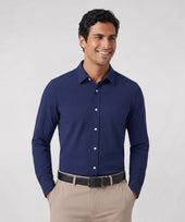 A man wearing the Everywear Shirt Standard Length in Navy with a button-down collar.