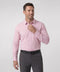 A man wearing the Everywear Shirt Standard Length in Soft Rose with a button-down collar.