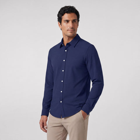A man wearing the Everywear Shirt Shorter Length in Navy with amber contrast thread details.