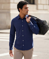 The Everywear Shirt Shorter Length in Navy worn in a lifestyle setting.