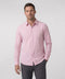 A man wearing the Everywear Shirt Shorter Length in Soft Rose with a classic button-down collar.