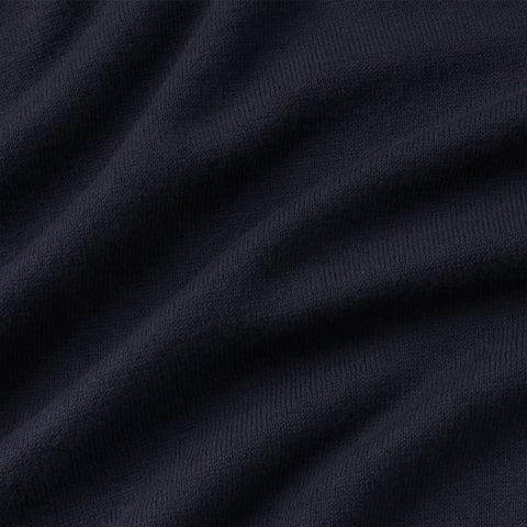 Close-up of the navy fine-knit fabric of the long-sleeve polo.