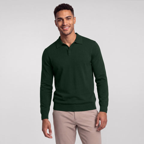 A dark pine green long-sleeve knit polo worn with stone chinos, front view.