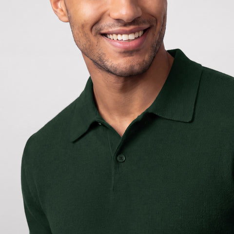 Close-up of a dark green knit long-sleeve polo with a two-button placket.