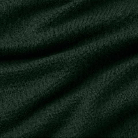 Close-up of the dark green fine-knit fabric of the long-sleeve polo.