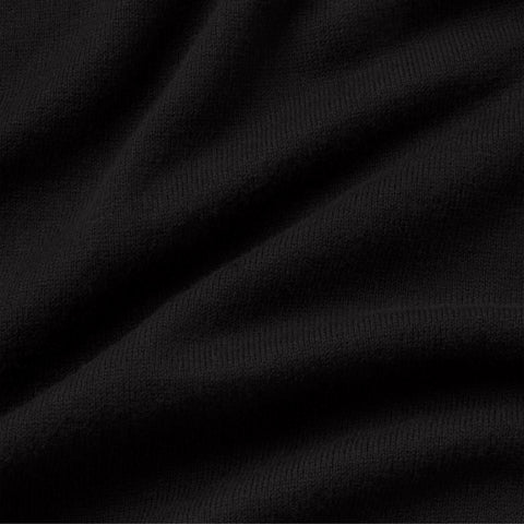 Close-up of the black fine-knit fabric of the long-sleeve polo.