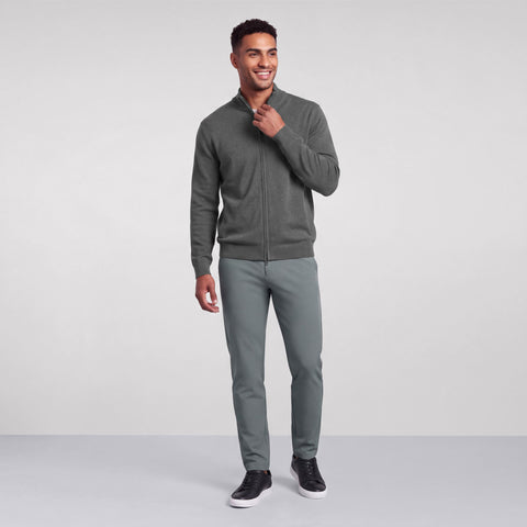 Full-length studio shot of a heather gray full-zip sweater worn with sage green pants.
