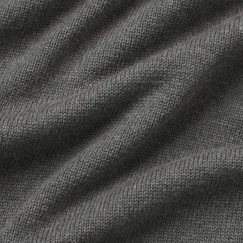 Close-up of the heather gray knit fabric of the full-zip sweater.
