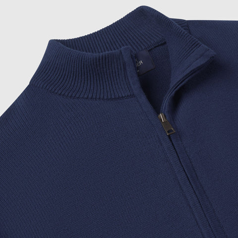 Detail of the ribbed collar, zipper pull and neck label on the navy full-zip sweater.