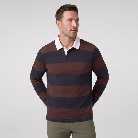 A man wearing the Rugby Polo in Chicory and Dark Navy