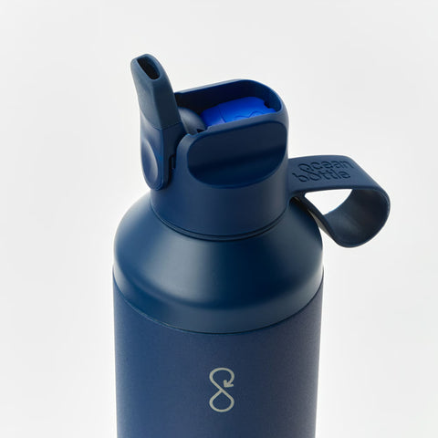 Close-up of the bottle's flip-top spout and carry loop, embossed Ocean Bottle.