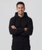Man wearing a black hoodie with arms crossed on a light gray background