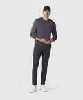 Precision Long Sleeve Tee in dark color, worn by a model, showcasing sleek design and fitted shoulders.