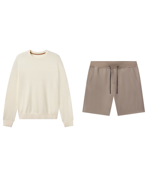 Ivory crewneck sweater paired with taupe drawstring shorts, shown flat.