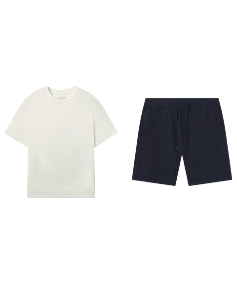 Off-white crewneck tee paired with navy drawstring shorts.