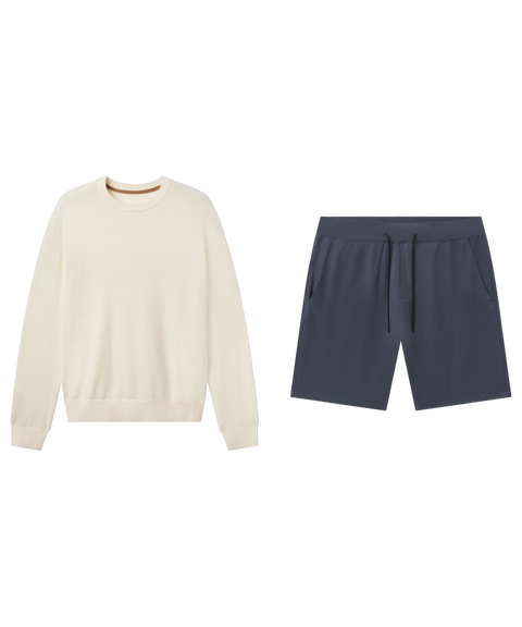 Cream crewneck sweater paired with slate blue drawstring shorts in a flat-lay outfit.