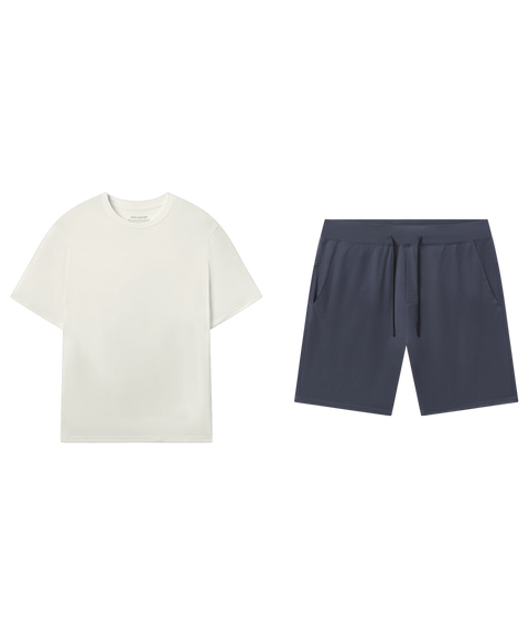 Ivory crewneck tee paired with slate blue drawstring shorts in a flat-lay outfit.