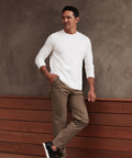 White Precision Long Sleeve Tee made from organic cotton, emphasizing shoulders, worn by a man.