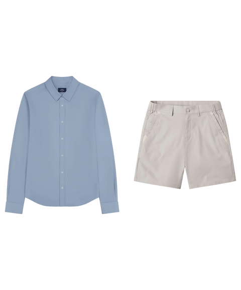 Chambray blue long-sleeve shirt laid flat beside light stone shorts.