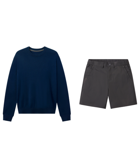 Navy crewneck sweater paired with charcoal gray shorts, shown flat.