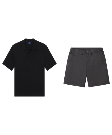 Black knit polo paired with charcoal tech shorts, shown flat.