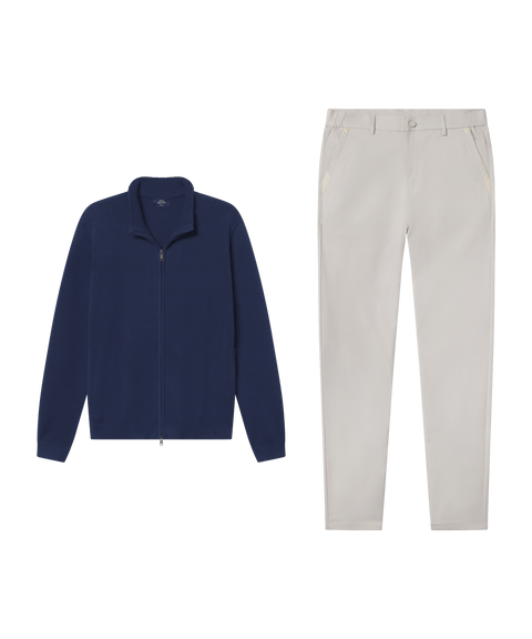 Navy full-zip sweater paired with stone chino pants.